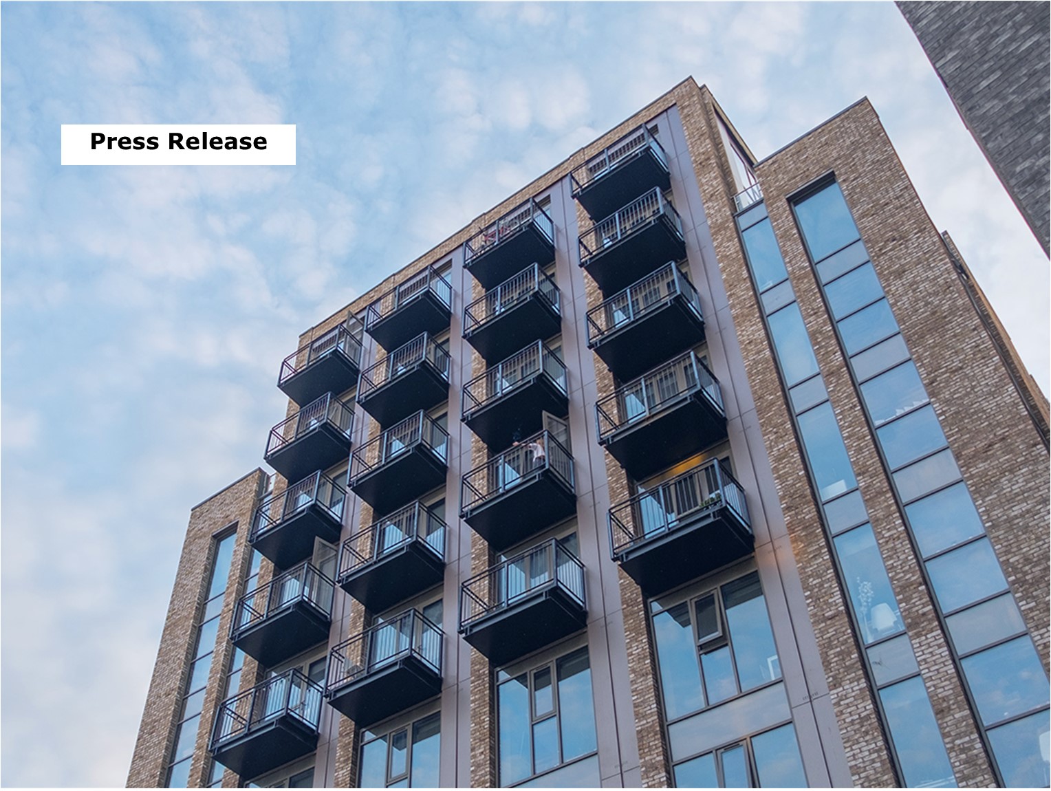 Press Release Family looking at front of house