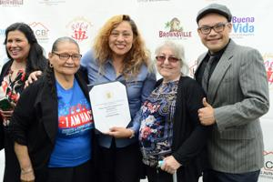 [U.S. Department of Housing and Urban Development EnVision Center Program Manager Unabyrd Wadhams reads from a certificate that designates Buena Vida Choice Neighborhood Headquarters in Brownsville an official EnVision Center Wednesday morning from the downtown Brownsville headquarters.]