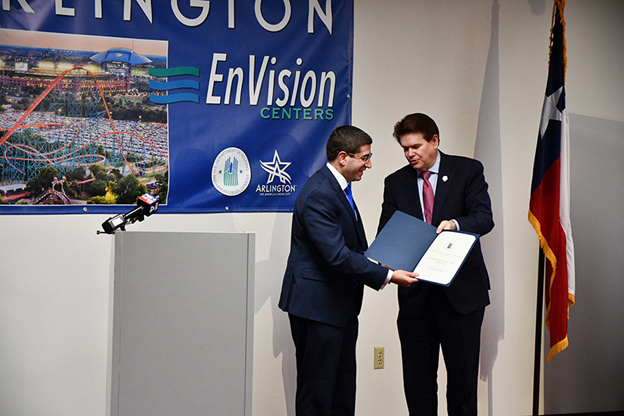 [Arlington Mayor Jeff Williams hands a proclamation to HUD Assistant Deputy Secretary for Field Policy and Management Benjamin DeMarzo. (City of Arlington photo)]