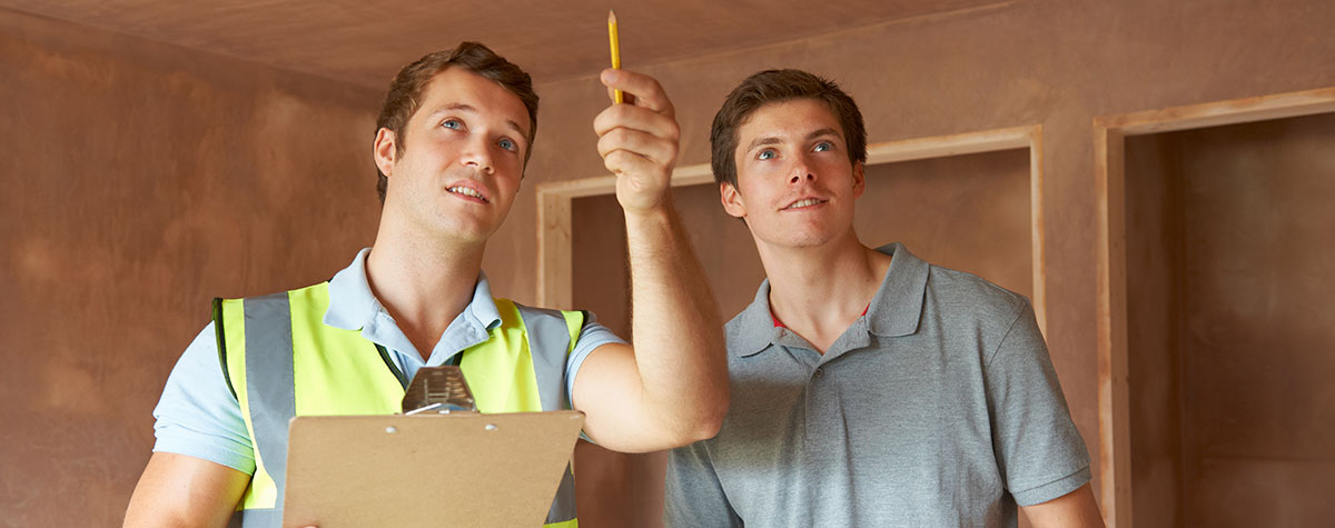 An inspector and property owner review a property together.