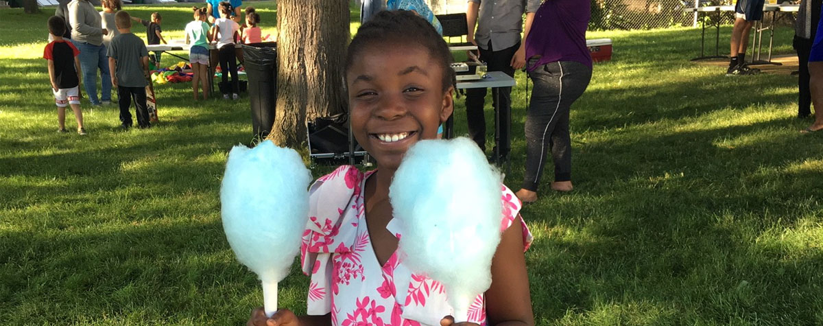 Participant enjoys cotton candy treat during Medford Housing Authority event in Medford, MA. HUD Photo