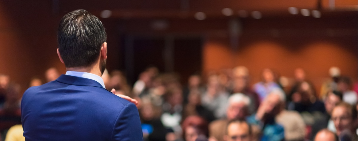 Event speaker addressing an audience. 